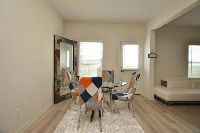 a dining room with furniture and window