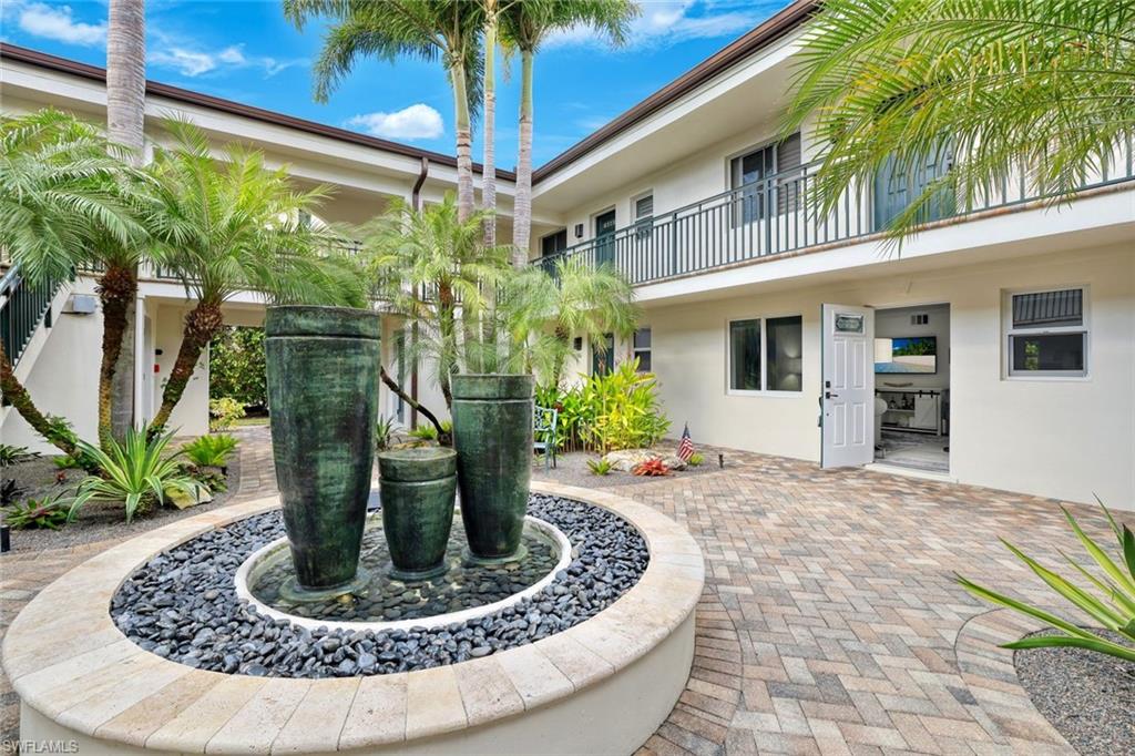 960 7th Street South, Unit 105 Naples, FL 34102 - Photo 16 of 19 Serene courtyard fountain offering a peaceful backdrop as you come and go.