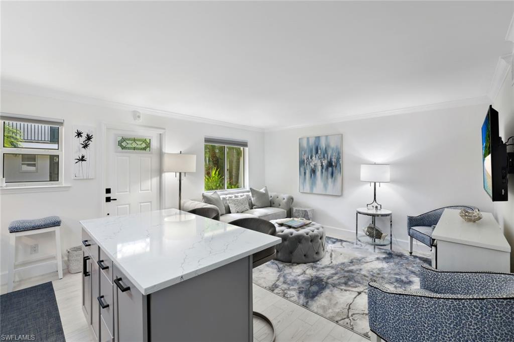 960 7th Street South, Unit 105 Naples, FL 34102 - Photo 6 of 19 Bright living area open to the kitchen making it great for entertaining guests.
