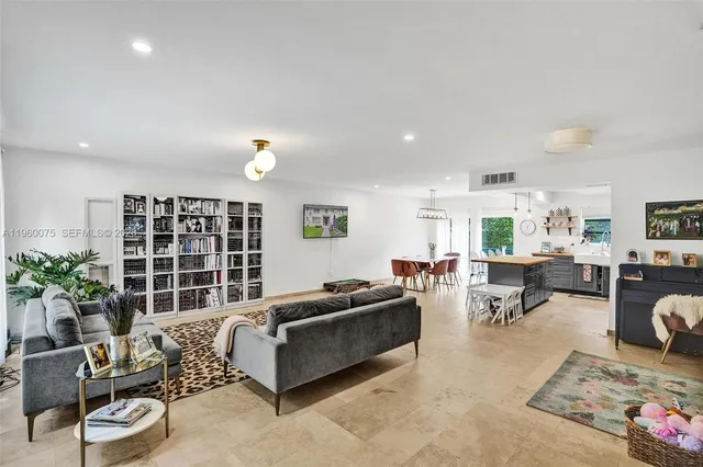 a living room with furniture window and potted plant