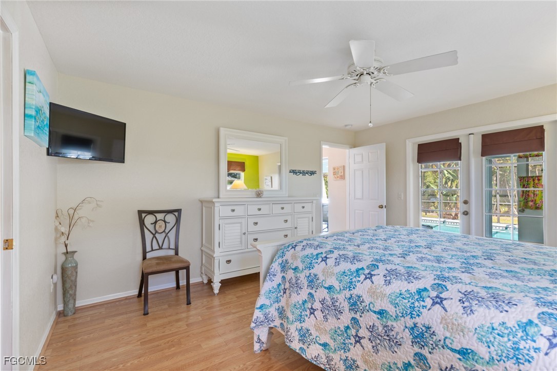 7660 Grande Pine Road Bokeelia, FL 33922 - Photo 13 of 33 a bedroom with a bed and a television