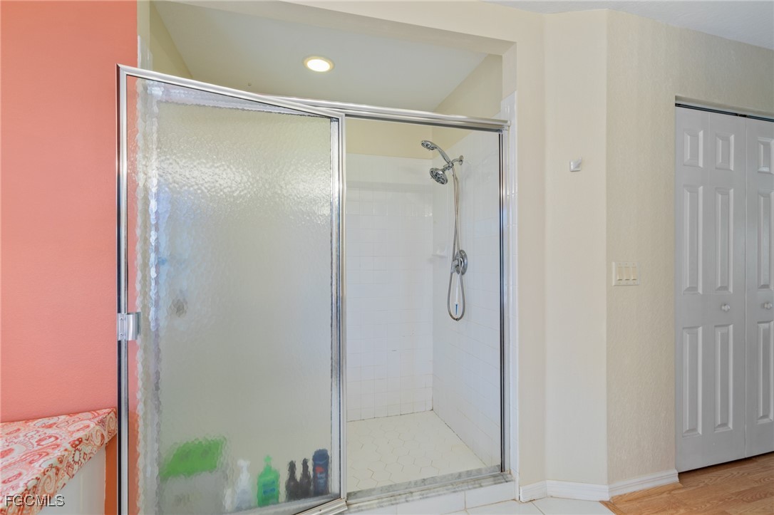 7660 Grande Pine Road Bokeelia, FL 33922 - Photo 15 of 33 a bathroom with a glass shower door