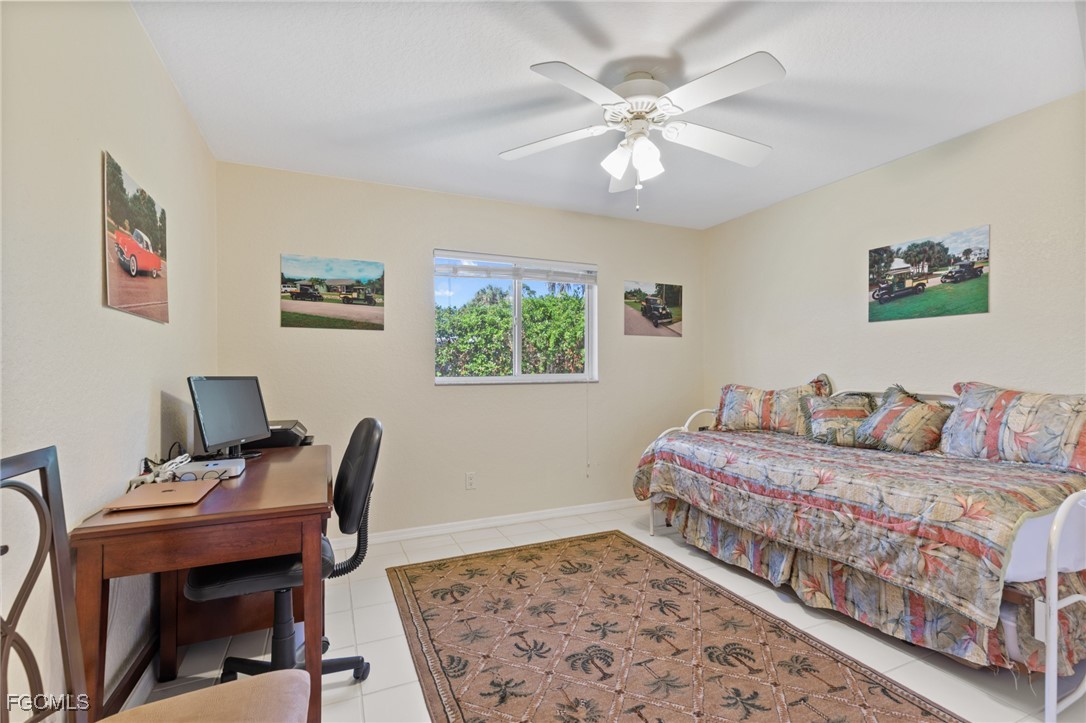 7660 Grande Pine Road Bokeelia, FL 33922 - Photo 16 of 33 a bedroom with a bed and a desk