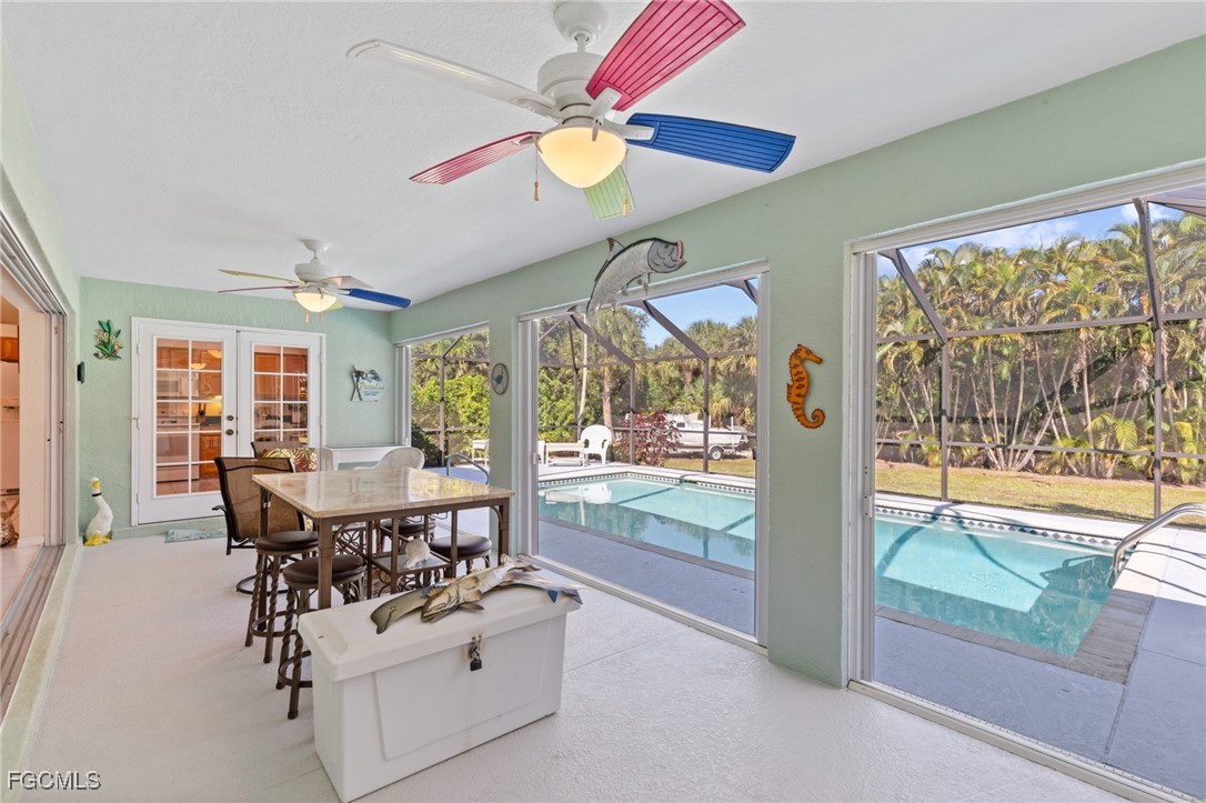 7660 Grande Pine Road Bokeelia, FL 33922 - Photo 20 of 33 a view of a dining room with furniture window and outside view