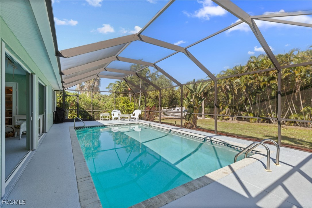 7660 Grande Pine Road Bokeelia, FL 33922 - Photo 2 of 33 a view of a swimming pool with a patio