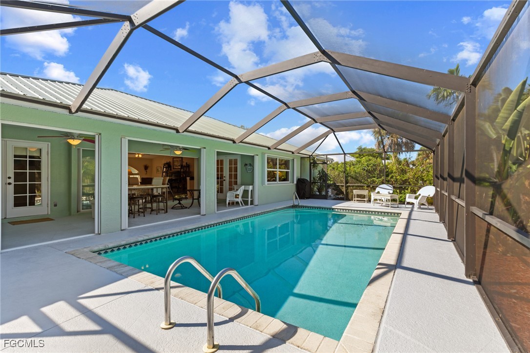 7660 Grande Pine Road Bokeelia, FL 33922 - Photo 22 of 33 a swimming pool with outdoor seating and yard