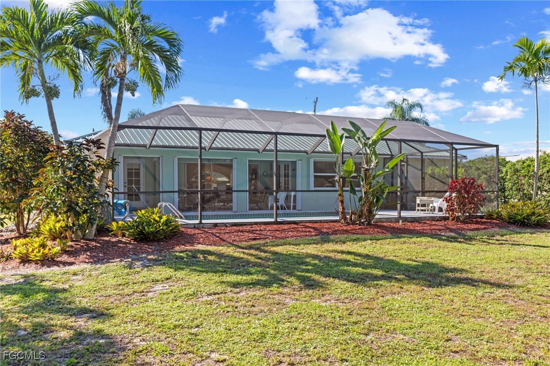 7660 Grande Pine Road Bokeelia, FL 33922 - Photo 24 of 33 a view of a house with backyard porch and sitting area