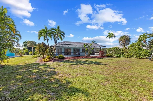 a front view of house with yard and swimming pool