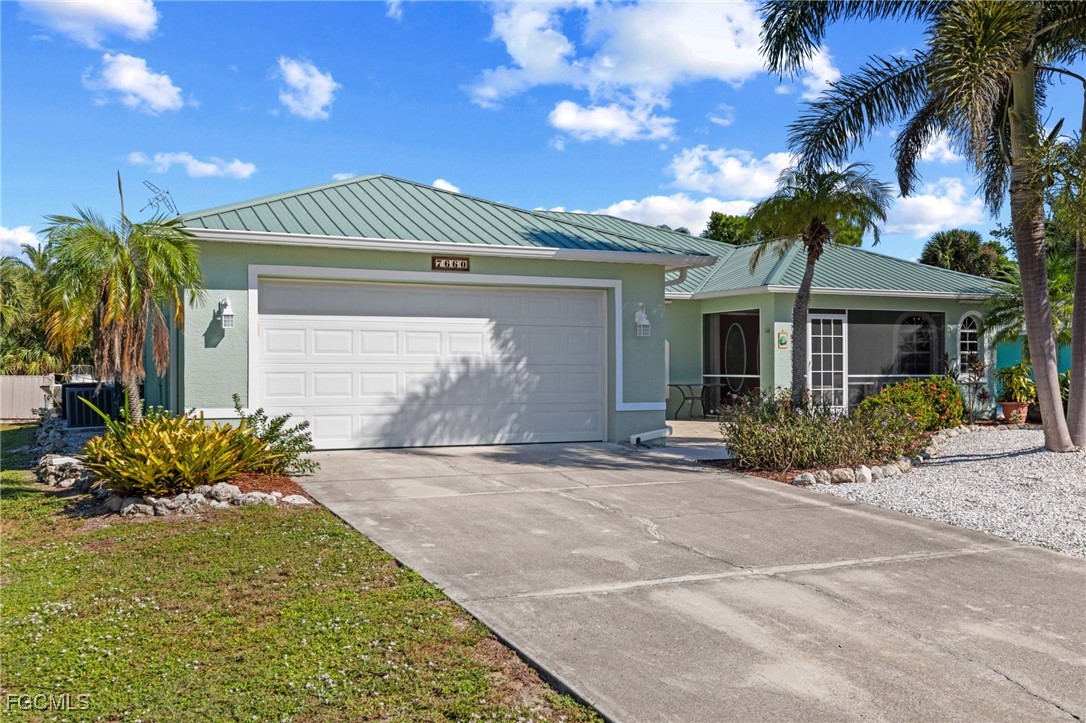 7660 Grande Pine Road Bokeelia, FL 33922 - Photo 27 of 33 a front view of a house with garden