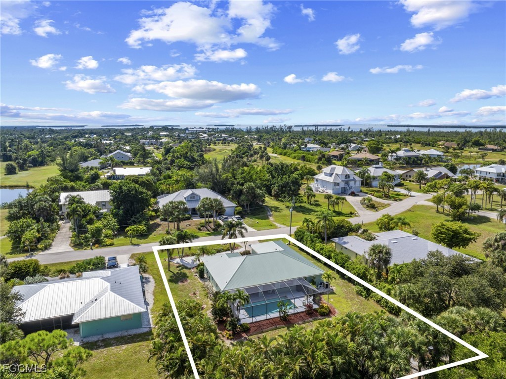 7660 Grande Pine Road Bokeelia, FL 33922 - Photo 29 of 33 a view of a city with lots of residential buildings ocean and mountain view in back