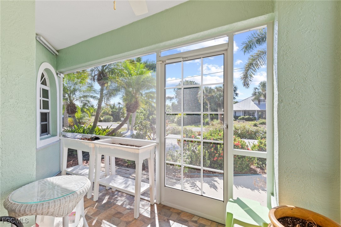 7660 Grande Pine Road Bokeelia, FL 33922 - Photo 3 of 33 a view of a dining room with furniture a chandelier and wooden floor