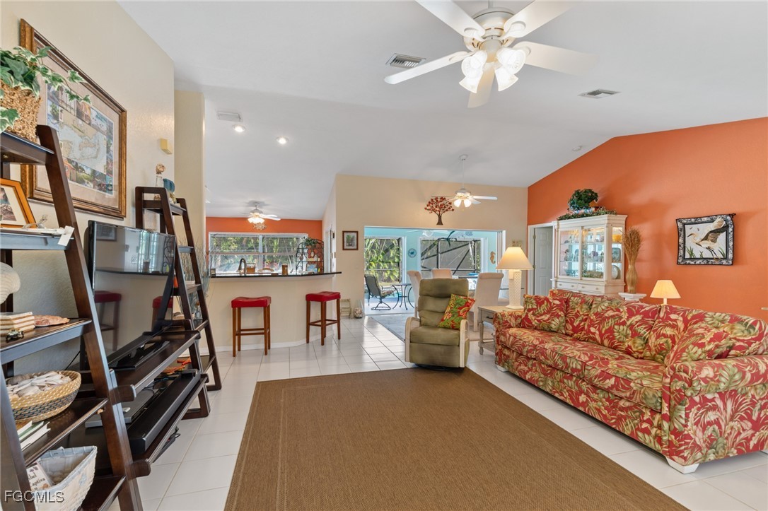 7660 Grande Pine Road Bokeelia, FL 33922 - Photo 5 of 33 a living room with furniture a rug and a chandelier