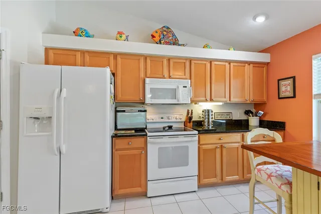 a kitchen with a white cabinets and white appliances