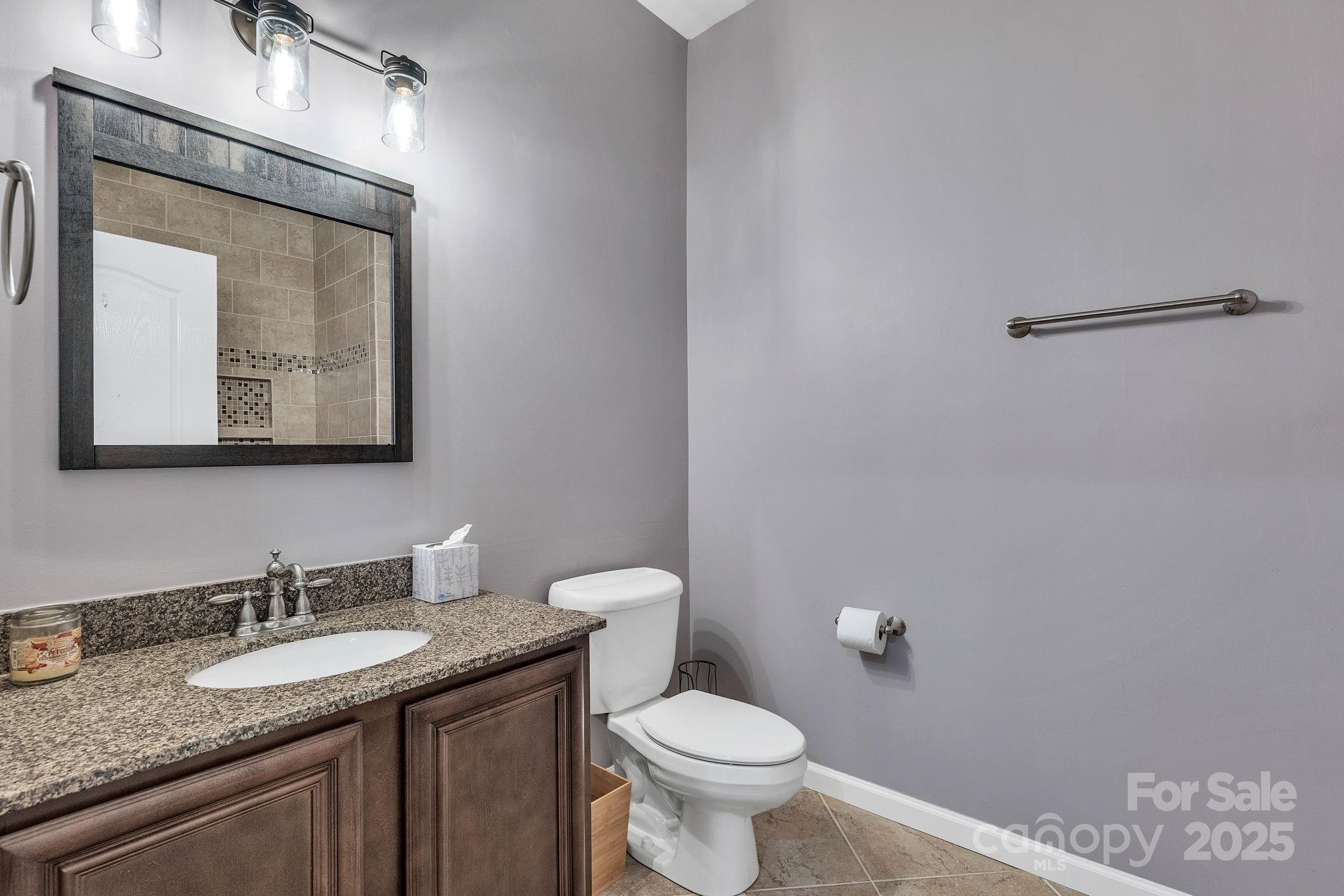 220 Alvin Hough Road Midland, NC 28107 - Photo 29 of 46 a bathroom with a granite countertop sink a toilet and mirror