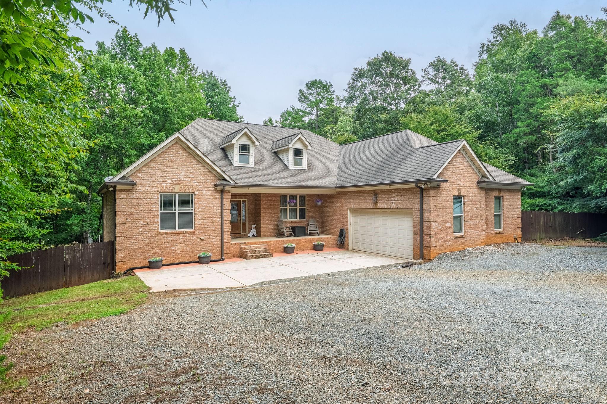 220 Alvin Hough Road Midland, NC 28107 - Photo 3 of 46 a front view of a house with a yard and garage