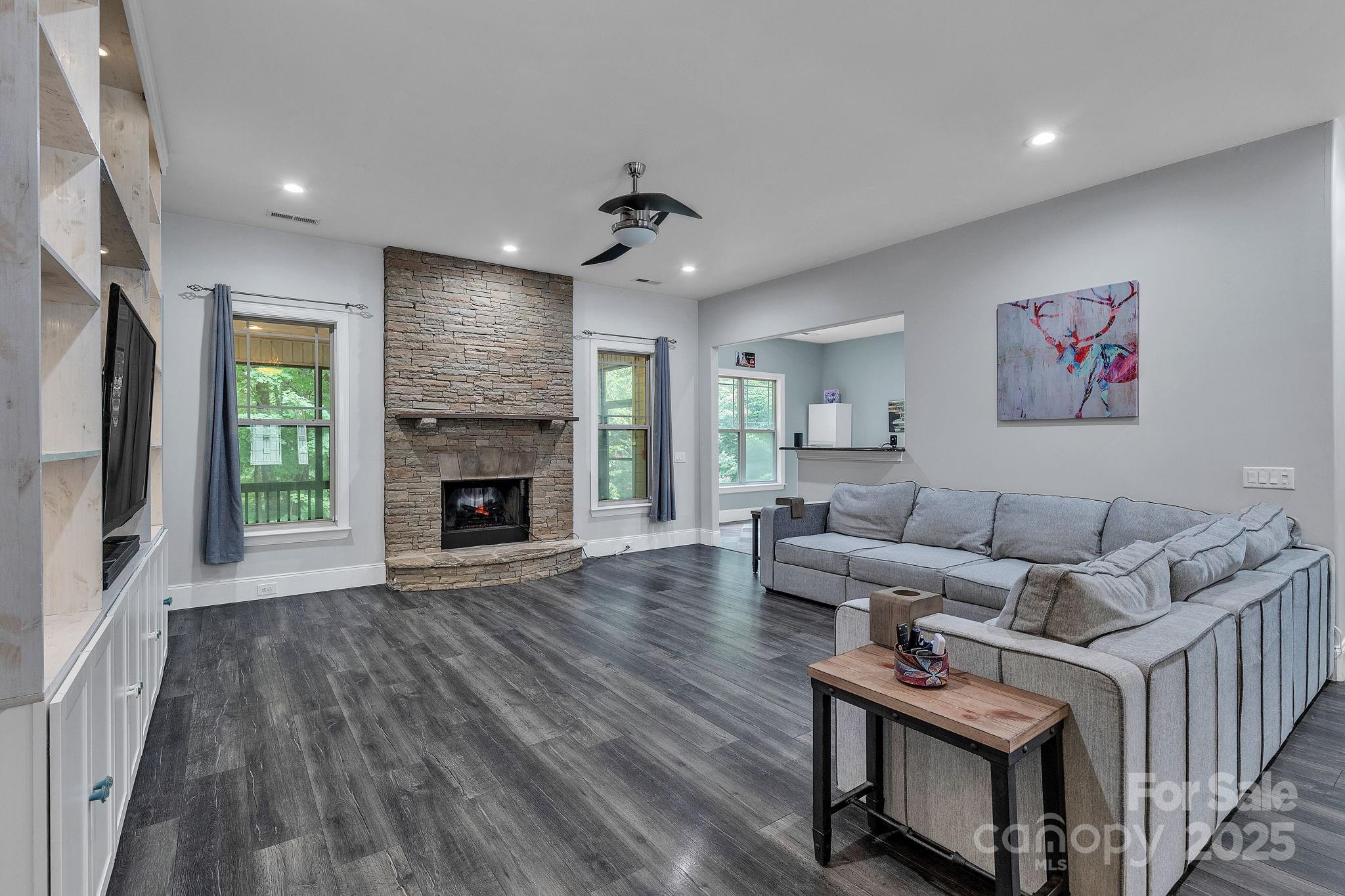 220 Alvin Hough Road Midland, NC 28107 - Photo 7 of 46 a living room with furniture a flat screen tv and a fireplace