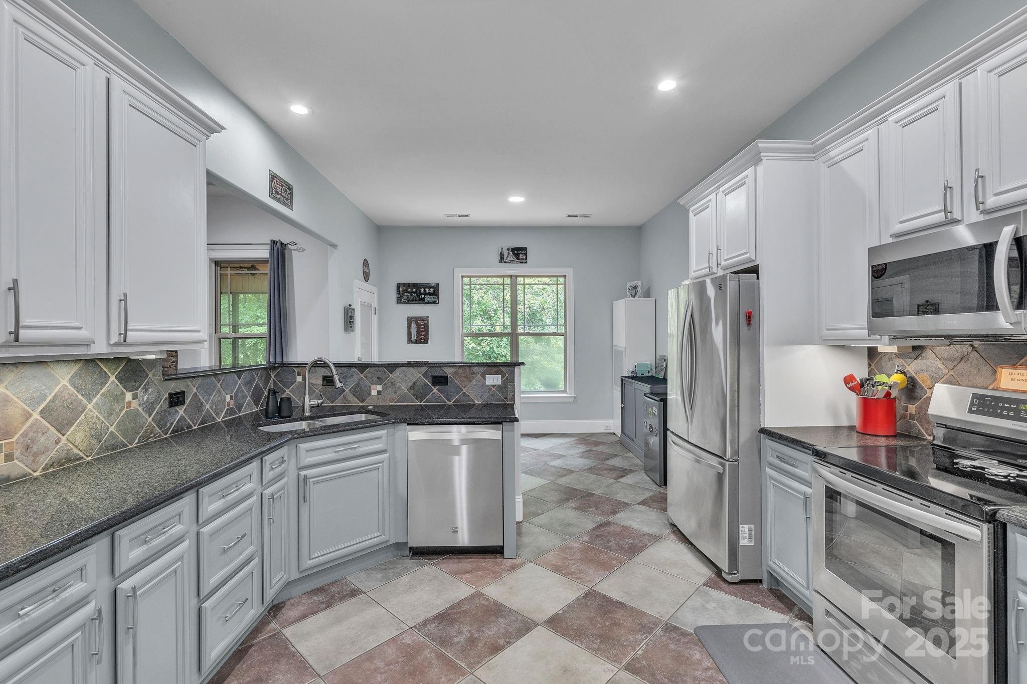 220 Alvin Hough Road Midland, NC 28107 - Photo 8 of 46 a kitchen with stainless steel appliances granite countertop a sink stove and refrigerator