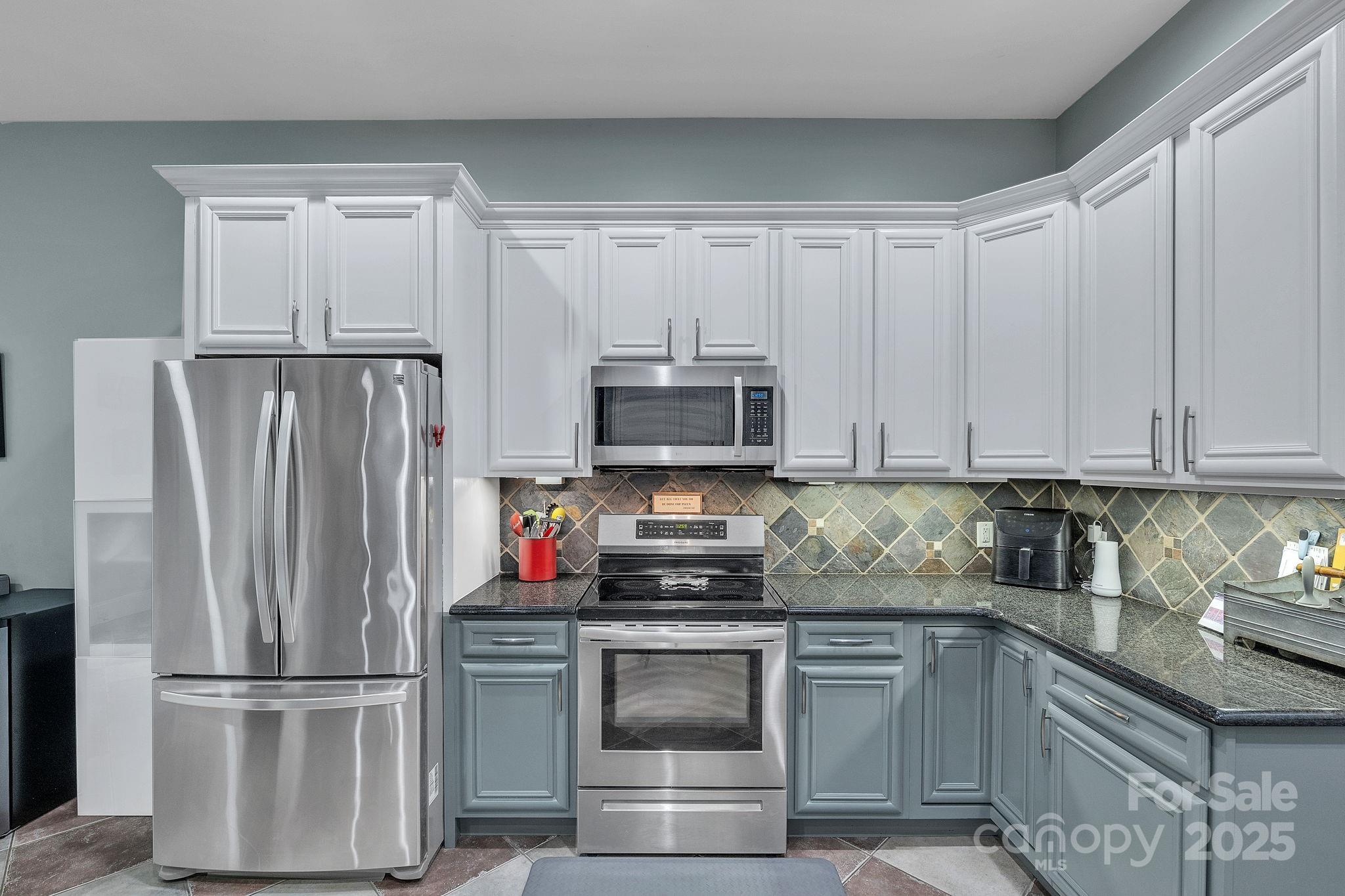 220 Alvin Hough Road Midland, NC 28107 - Photo 10 of 46 a kitchen with refrigerator a microwave and cabinets