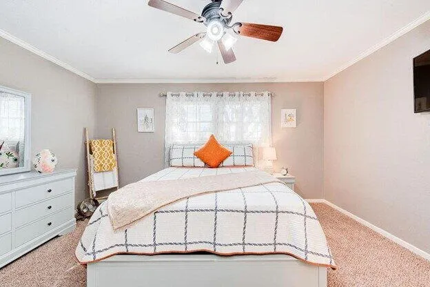 a bedroom with a bed and window