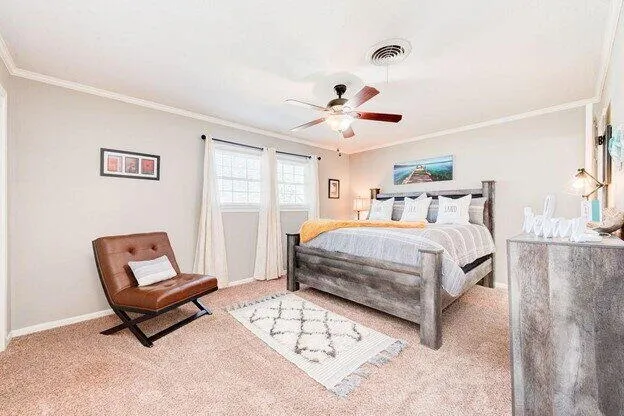 a bedroom with a bed a window and couch