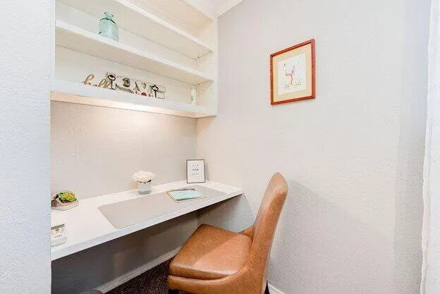 a bathroom with a sink a table and a chair