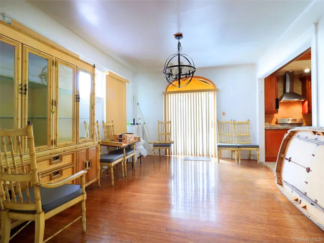 a view of a bedroom with furniture window and wooden floor