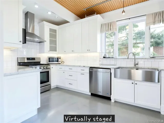 a kitchen with white cabinets and white appliances