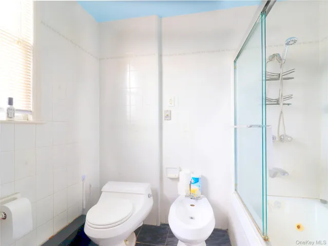 a white toilet sitting next to a bathroom sink