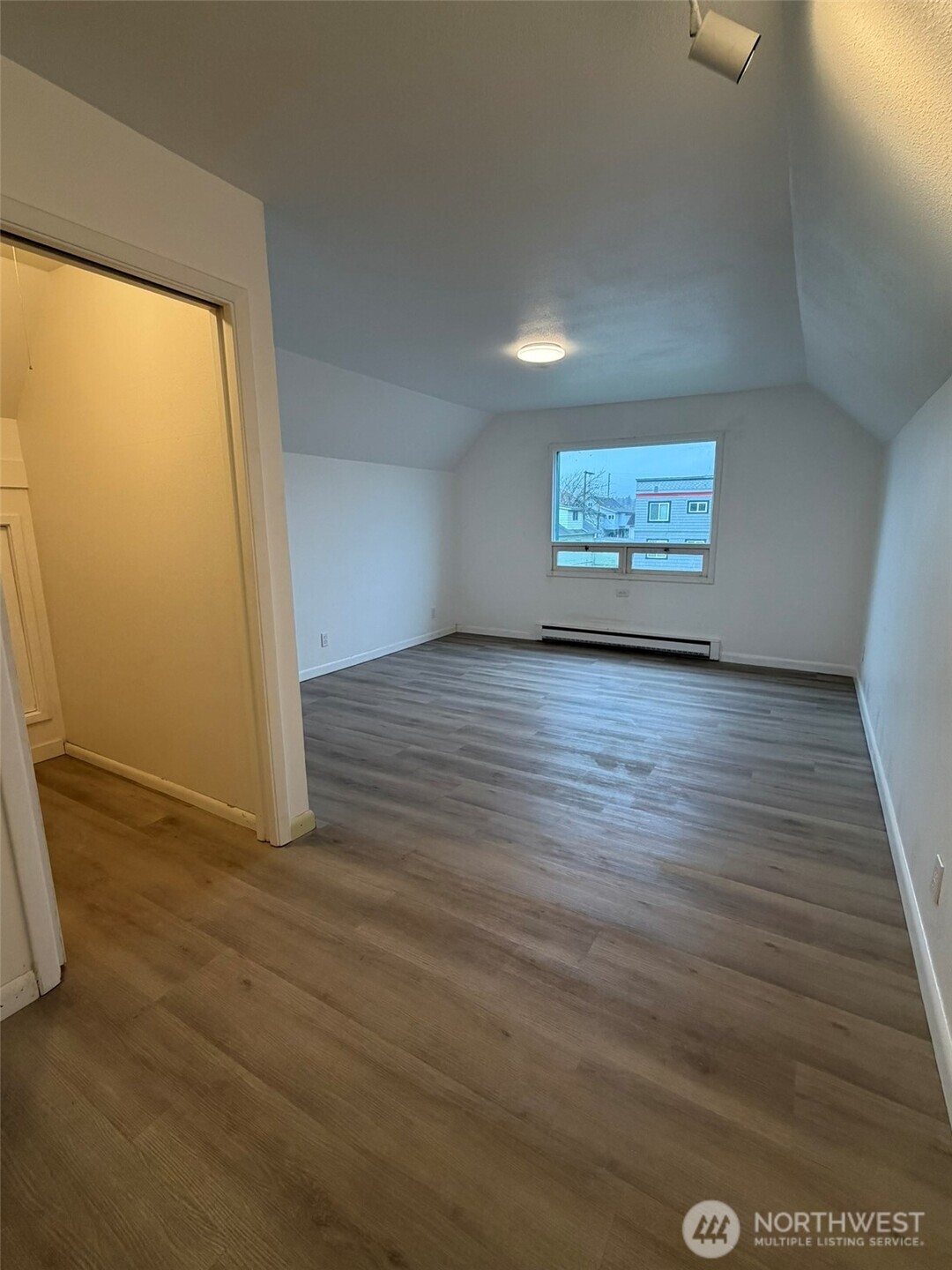 809 West Market Street Aberdeen, WA 98520 - Photo 29 of 39 an empty room with wooden floor and windows
