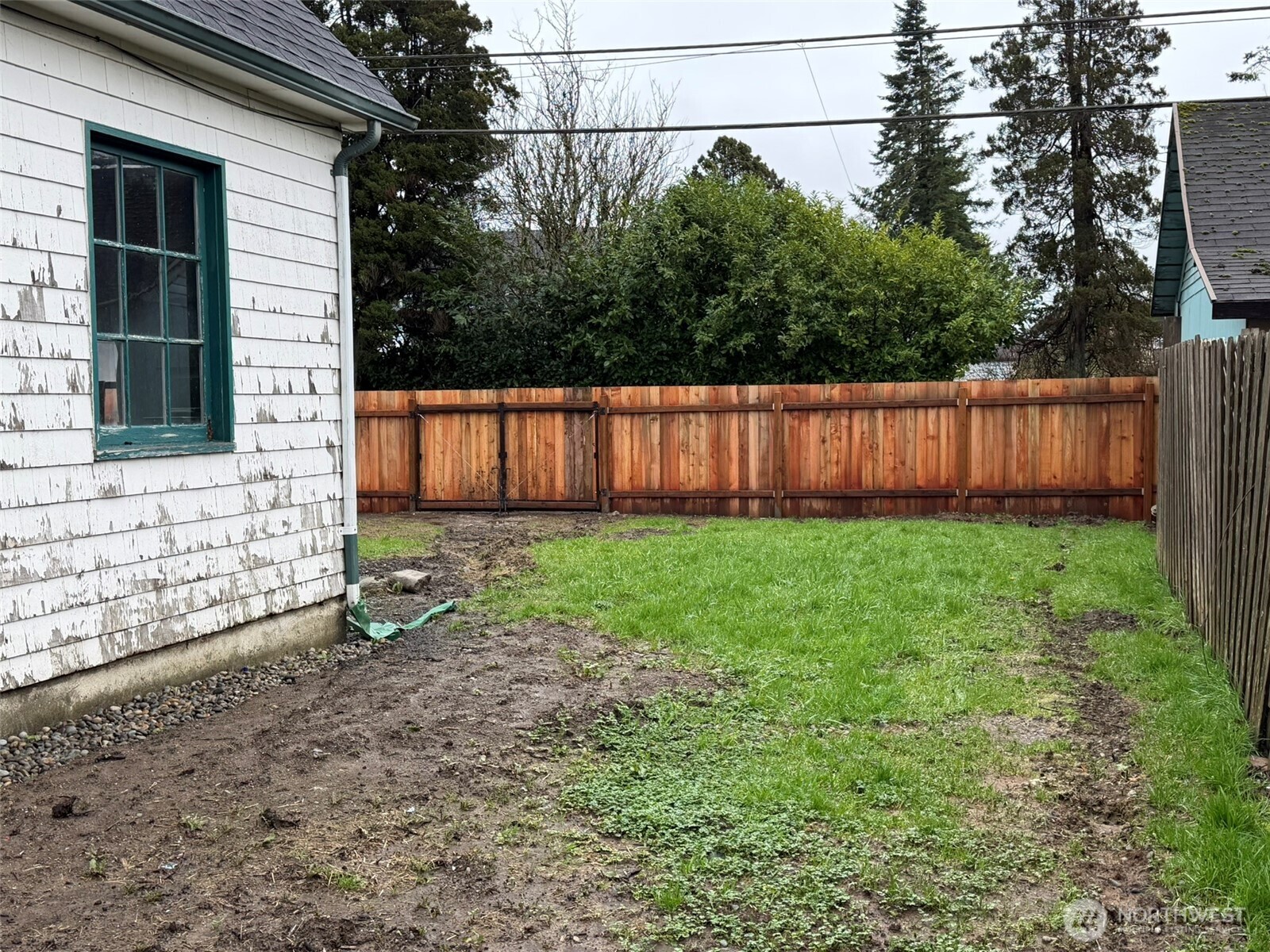 809 West Market Street Aberdeen, WA 98520 - Photo 37 of 39 a view of a backyard with potted plants and wooden fence
