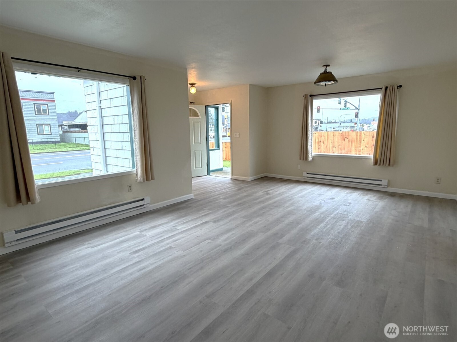 809 West Market Street Aberdeen, WA 98520 - Photo 10 of 39 an empty room with wooden floor and windows