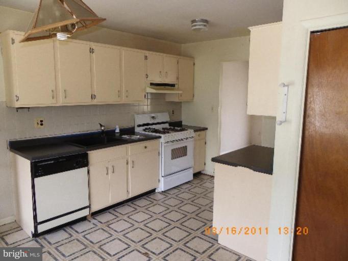 3510 Castleleigh Road Beltsville, MD 20705 - Photo 3 of 7 a kitchen with granite countertop a sink and a stove