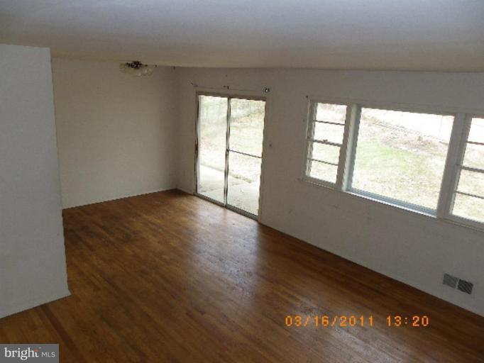 3510 Castleleigh Road Beltsville, MD 20705 - Photo 4 of 7 a view of an empty room with wooden floor and a window