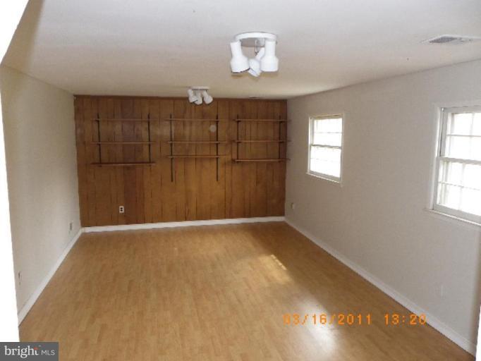 3510 Castleleigh Road Beltsville, MD 20705 - Photo 5 of 7 an empty room with windows and chandelier fan