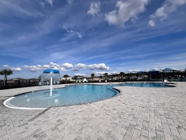 swimming pool view with a lake view in back