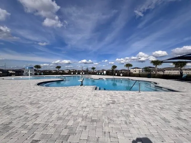 a view of swimming pool with outdoor seating