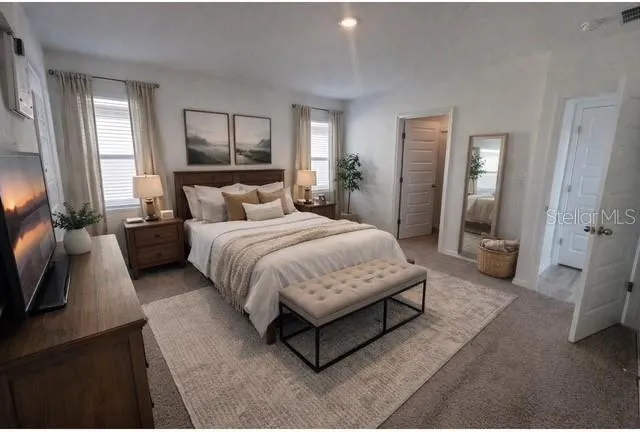 a spacious bedroom with a bed and a couch