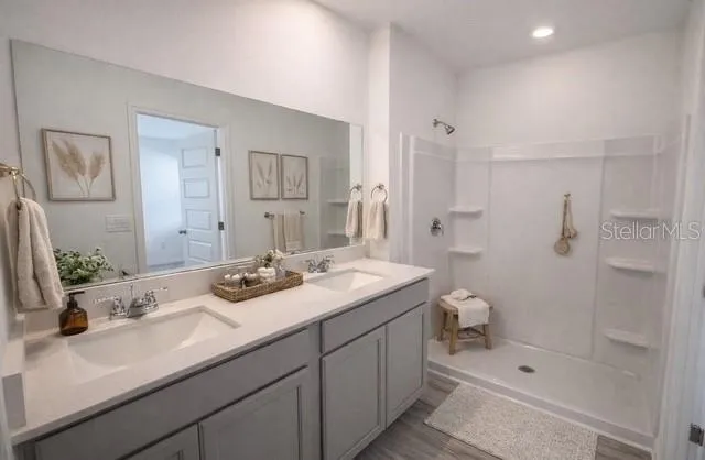 a bathroom with a sink a toilet and shower