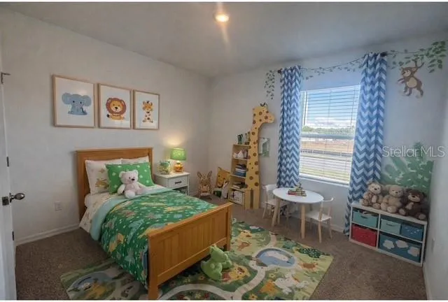 a bed sitting in a bedroom next to a window and a chair