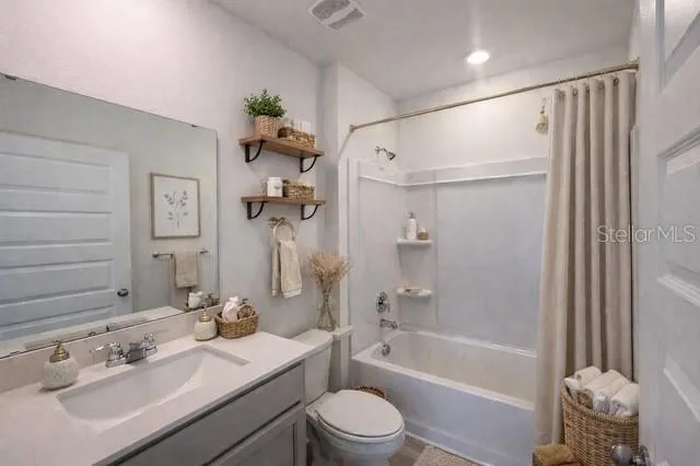 a bathroom with a sink toilet tub and shower