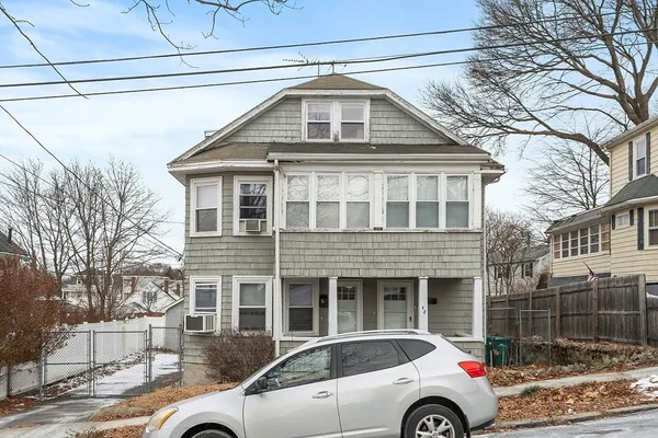 a view of a car parked in front of a house