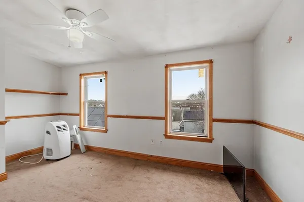 a view of a room with gym equipment and a window