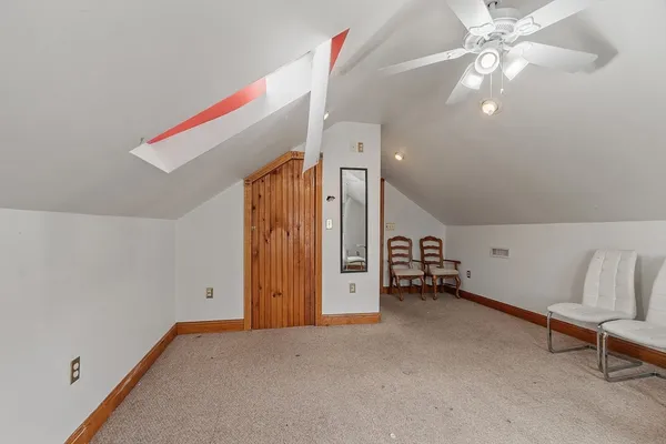 a view of a livingroom with furniture and a ceiling fan