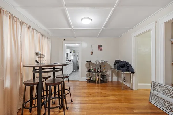 a view of a dining room with furniture and wooden floor