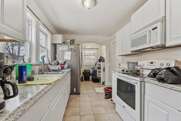 a kitchen that has a sink and a stove
