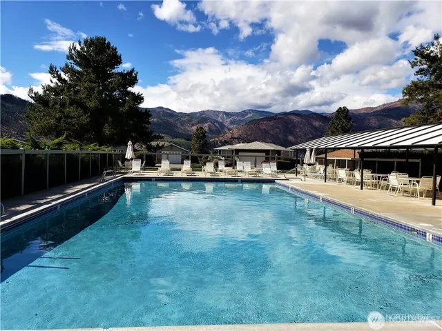 a view of a swimming pool with an outdoor seating