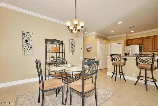 a view of a dining room with furniture and a chandelier