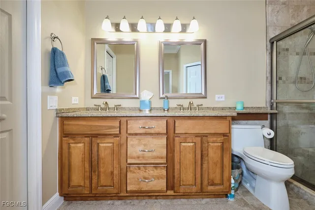 a bathroom with a sink a toilet and mirror