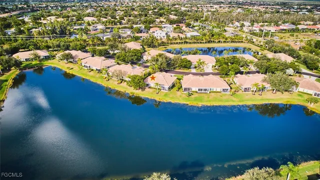 an aerial view of residential houses with outdoor space and lake view