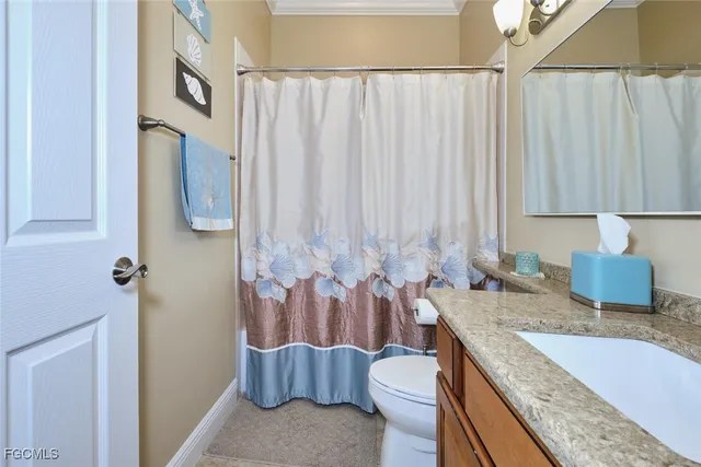 a bathroom with a granite countertop bathtub sink vanity and toilet